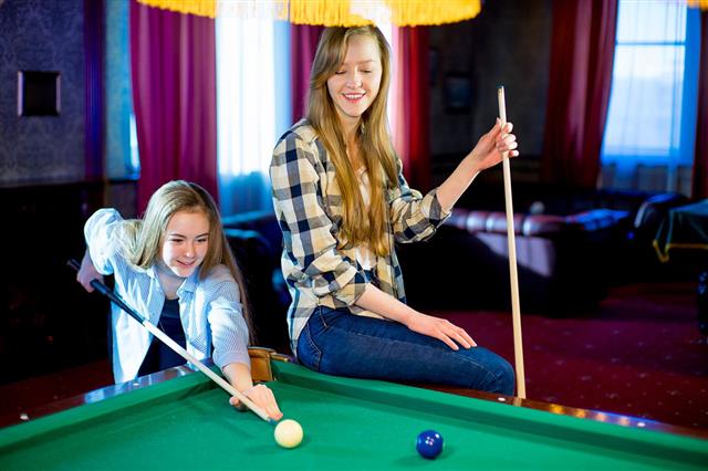 Two Girls Playing Billiard