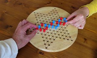 Couple Playing Chinese Checkers