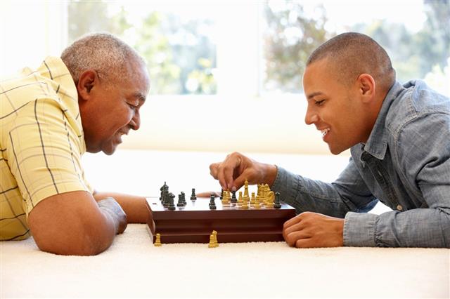 Man Playing Chess With Son