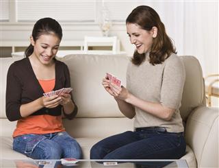 Mother And Daughter Playing Cards