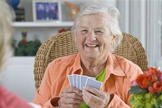 Senior Woman Playing A Card Game