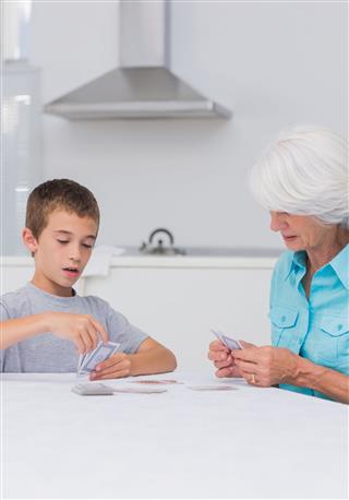 Grandson And His Grandmother Playing Cards