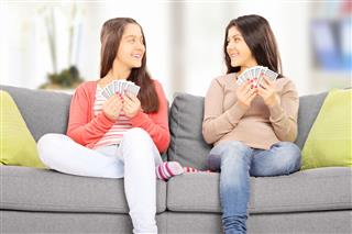 Teenage Girls Playing Cards At Home