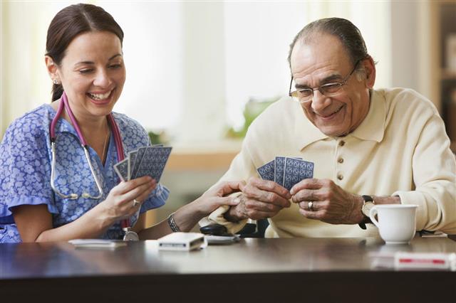 Nurse And Elderly Man Playing Cards