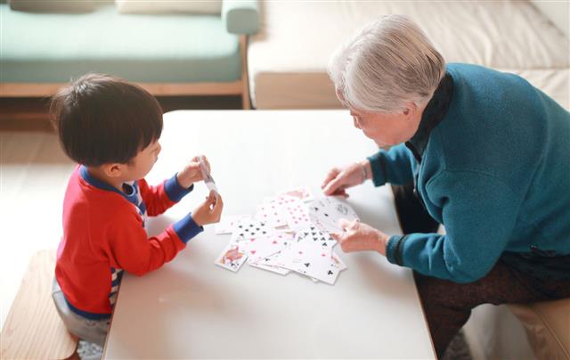 Happy Grandma And Grandson Playing Cards