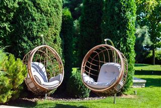 Two Hanging Chairs In Garden