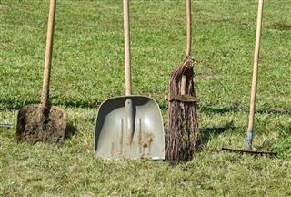 Shovel and broom and rake