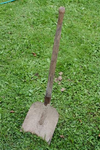 Old Shovel Stuck Into The Ground