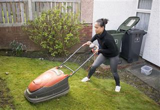 Woman Mowing Lawn