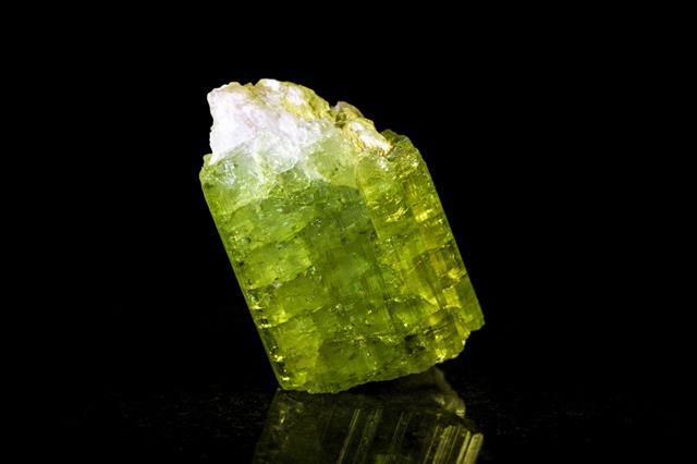 Green Tourmaline In Front Of Black