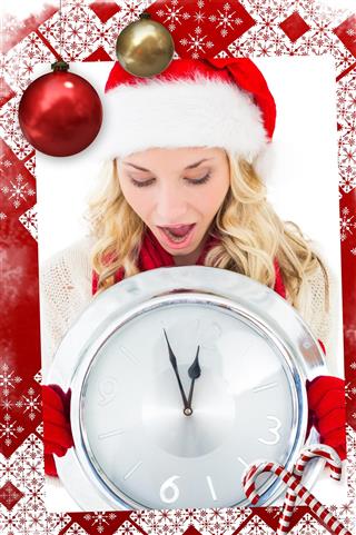 Festive blonde holding large clock