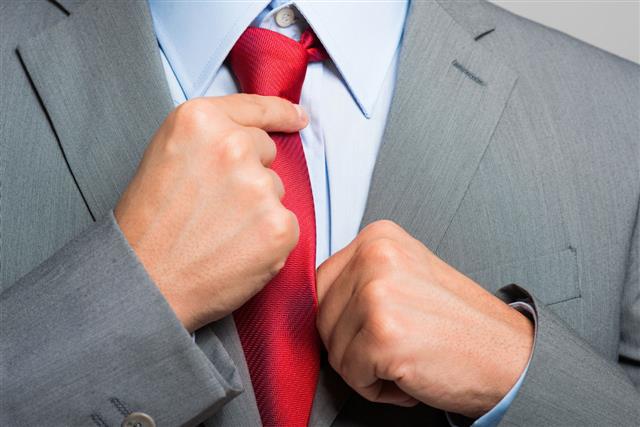 Businessman Adjusting His Tie