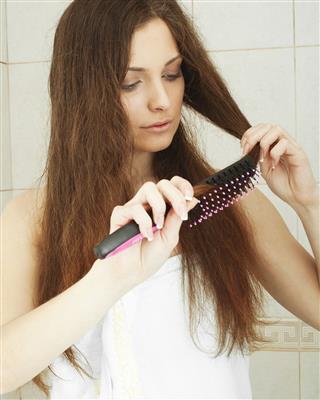Brunette Lady Combing Long Hair