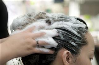 Woman Washing Hair At Beauty Salon