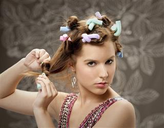 Woman With Colorful Curlers In Hair
