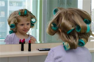 Girl With Curlers Doing Make Up