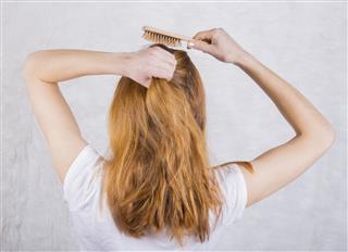 Young Woman Combing Hair