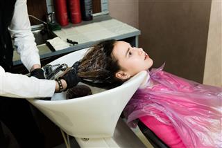 Woman Washing Hair At Hair Salon