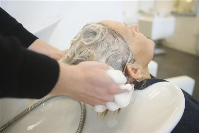 Senior Woman Getting Hair Washed In Parlor