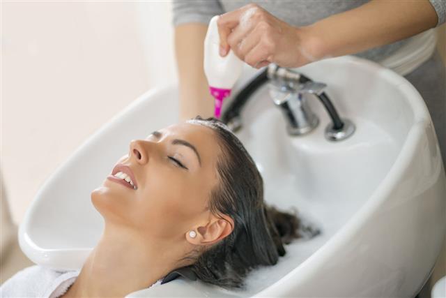Woman Washing Hair In Beauty Salon