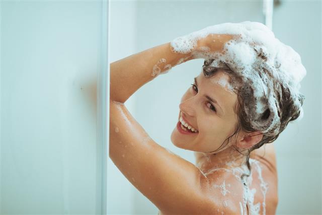 Young Woman Washing Head With Shampoo