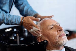 Old Man Washing His Hair In Salon