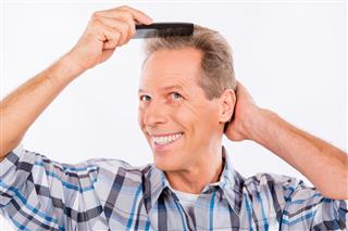 Happy Man Combing His Hair