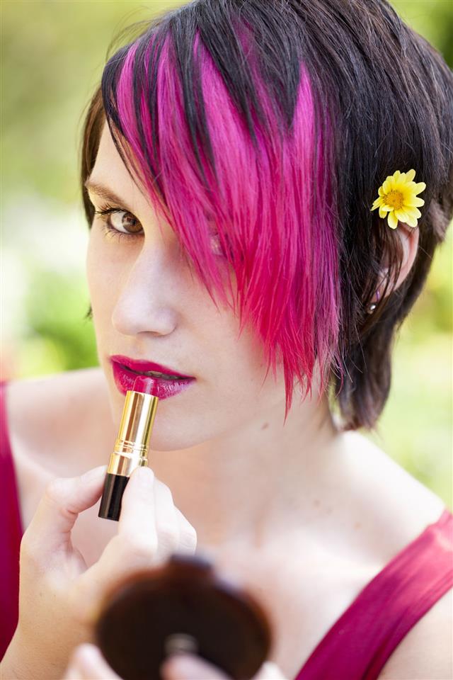 Punk Woman Applying Lipstick