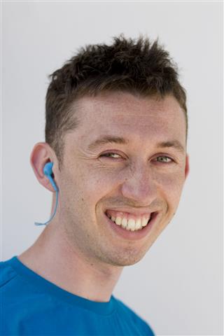 Smiling Young Man With Earphone