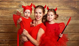 Happy Family With Costumes Devil