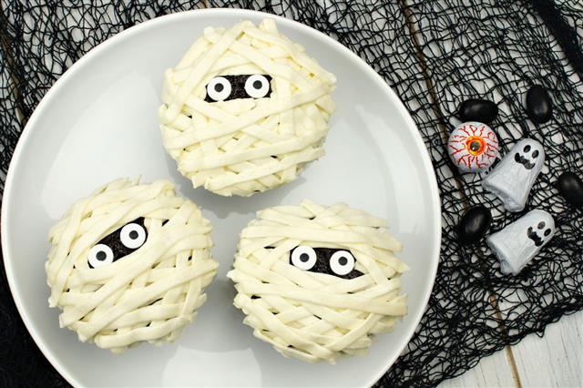 Halloween Mummy Cupcakes On White Plate