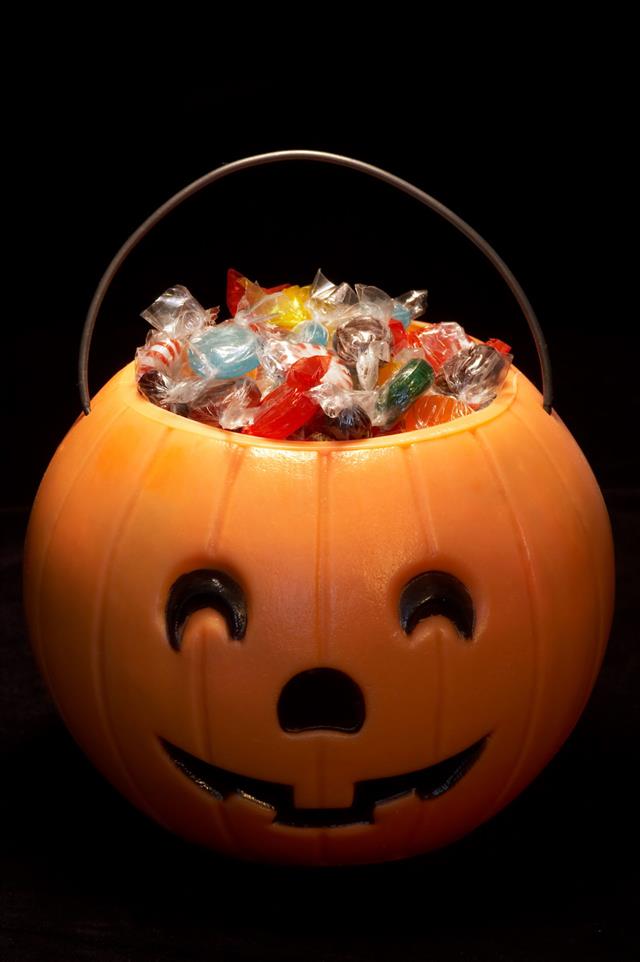 A Carved Halloween Pumpkin Filled With Candies