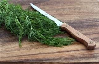 Dill And Knife On Cutting Board