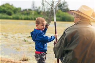 Grandfather With Grandson On Fishing