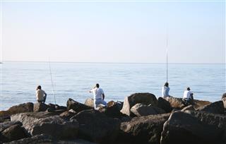Fishermen On The Rocks