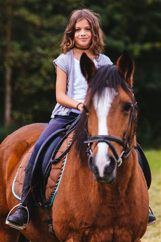 Cute Smiling Girl Riding Her Horse