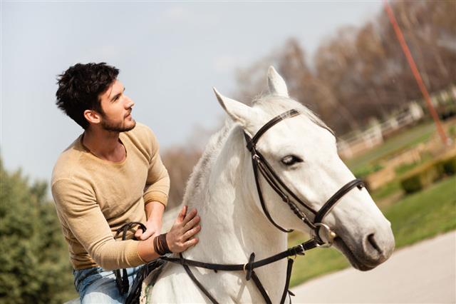 Young Man Riding A Horse