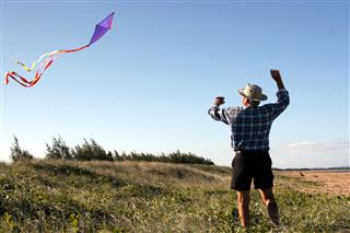 Senior Man Flying A Kite