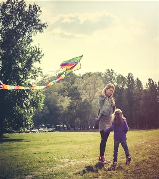 Mother And Daughter Flying Kite