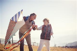 Flying A Kite With Grandfather