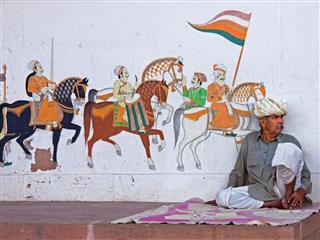 Man Sitting In Front Of Street Art