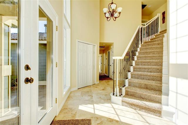 Entryway With Staircase And Tile Flooring