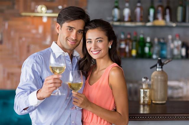Couple Holding Glass Of Wine