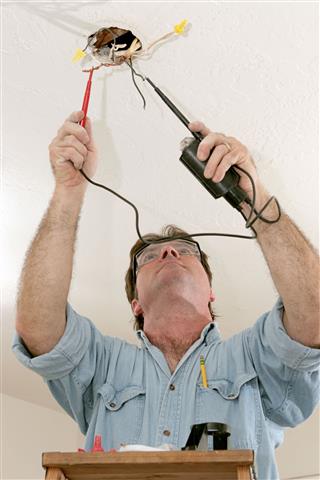 Electrician Testing Voltage Of Wires