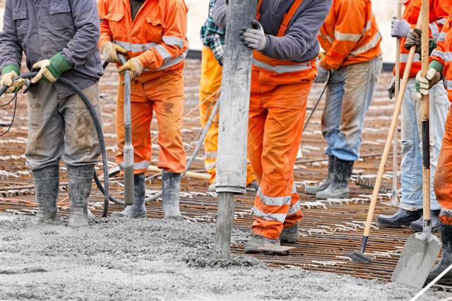 Construction Workers Pour Concrete