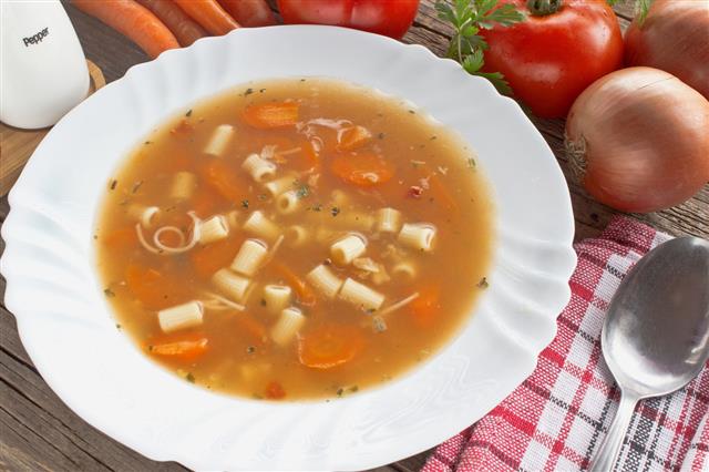 Minestrone Soup In Plate On Wooden Table