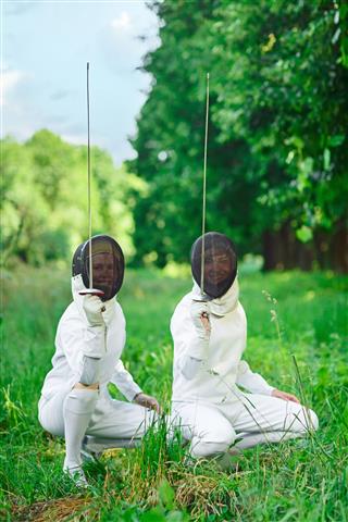 Two Fencers Women Squatting Down