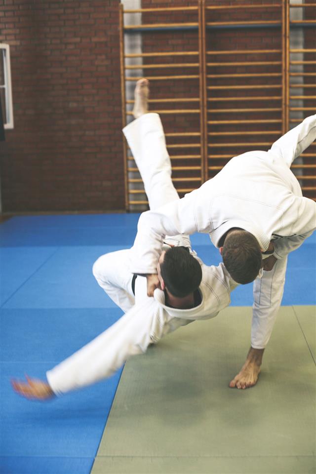 Two Young Males Practicing Judo Together