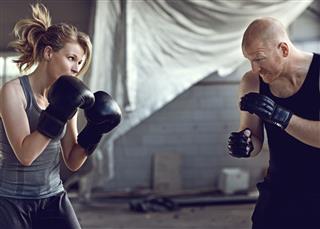 Boxer Sparring With Her Trainer