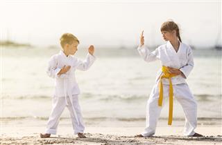 Practicing Karate On Beach